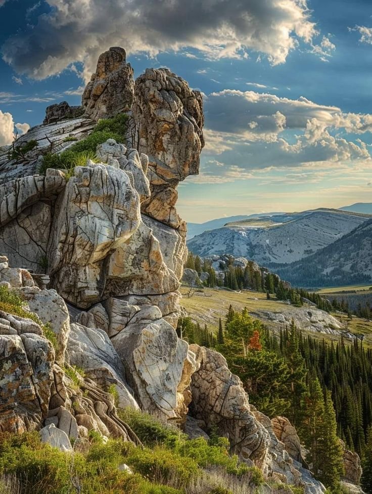 This may contain: a rocky mountain with trees and clouds in the background