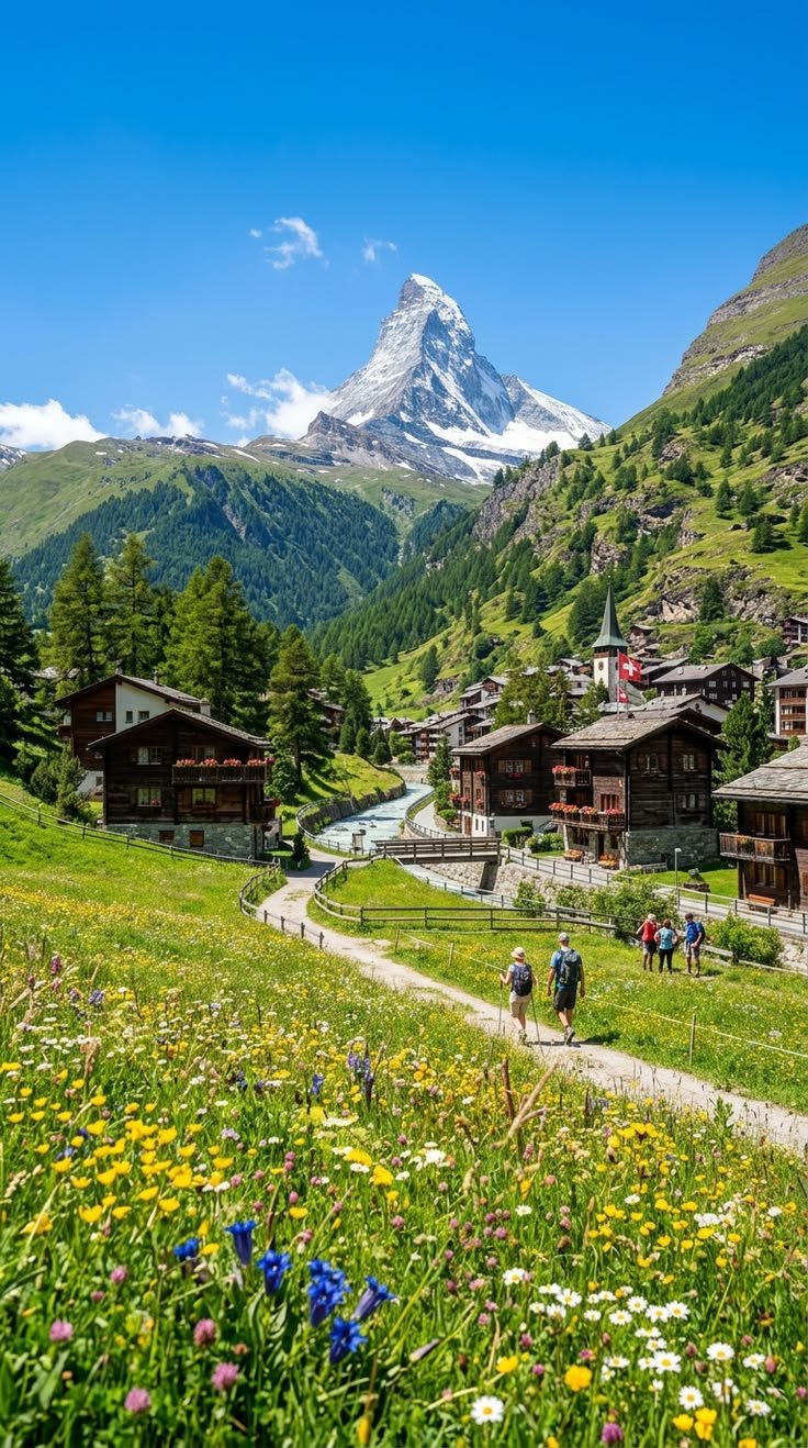 This may contain: some people are walking down a path in the mountains