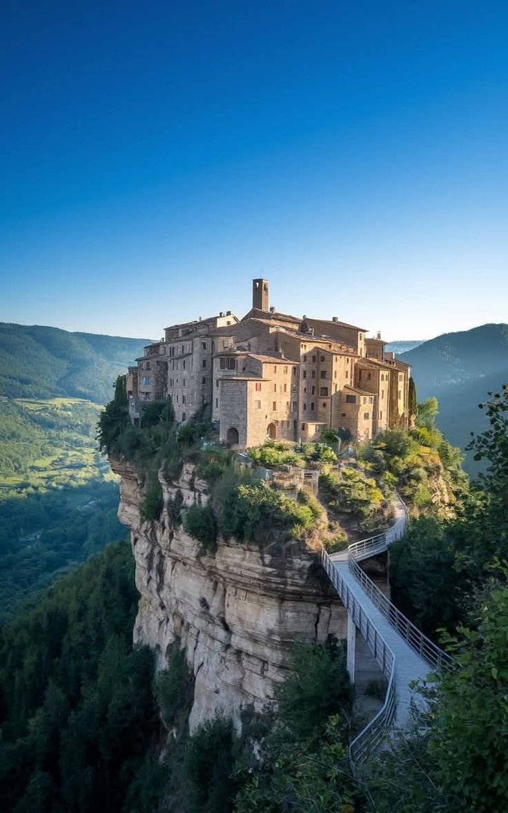 This may contain: an old castle perched on top of a cliff