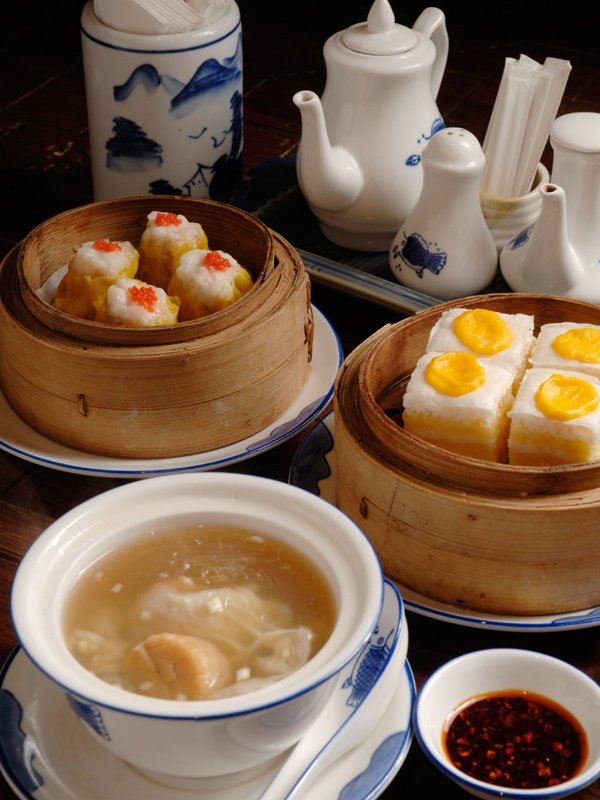 This may contain: there are some food on the table and bowls in front of them, including rice cakes