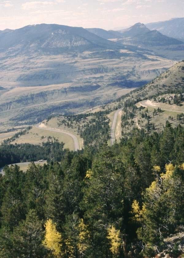 This may contain: a scenic view of the mountains and road