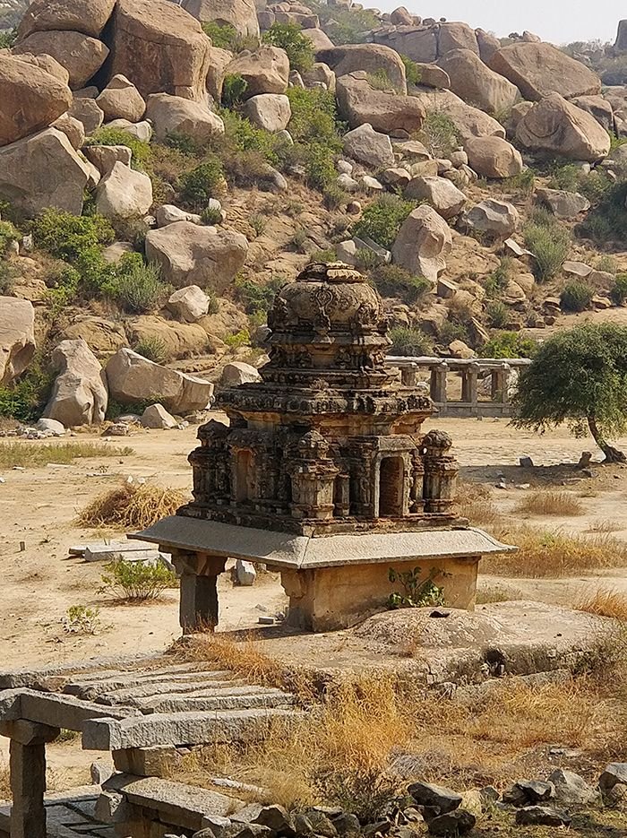 This may contain: a stone structure in the middle of some rocks