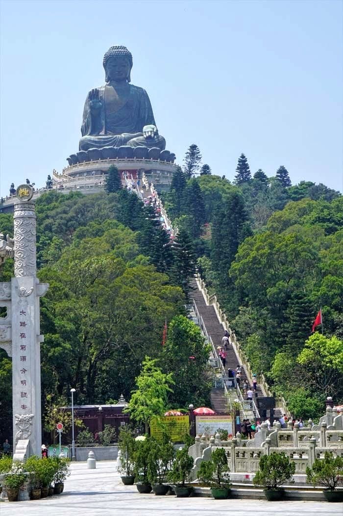 This may contain: there is a large statue on top of a hill with stairs leading up to it