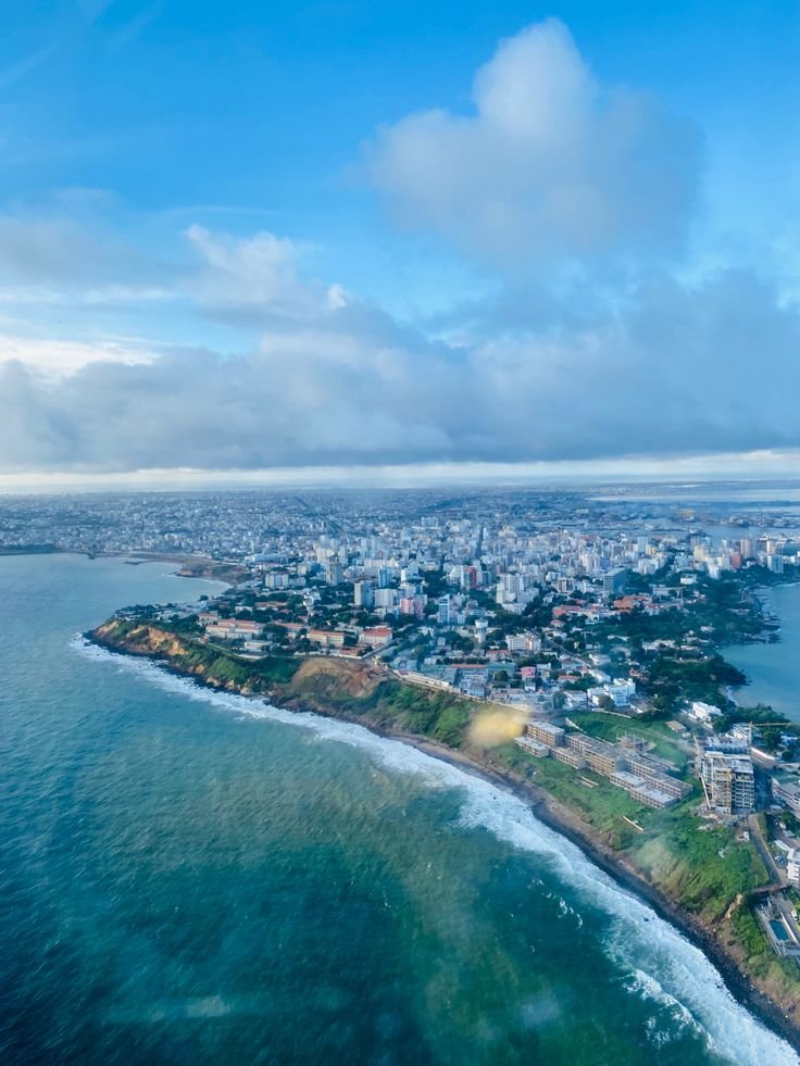 This may contain: an aerial view of a city and the ocean