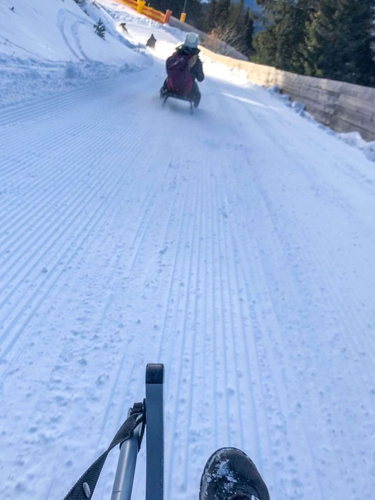 This may contain: someone is riding their snowmobile down the hill