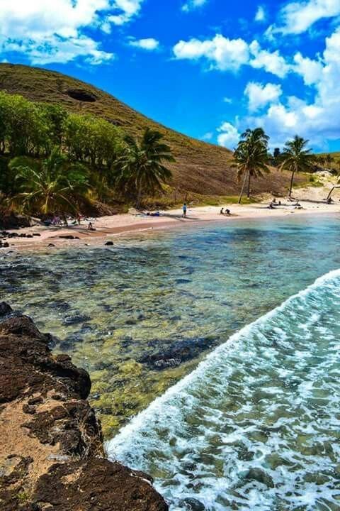 This may contain: the beach is surrounded by palm trees and clear water