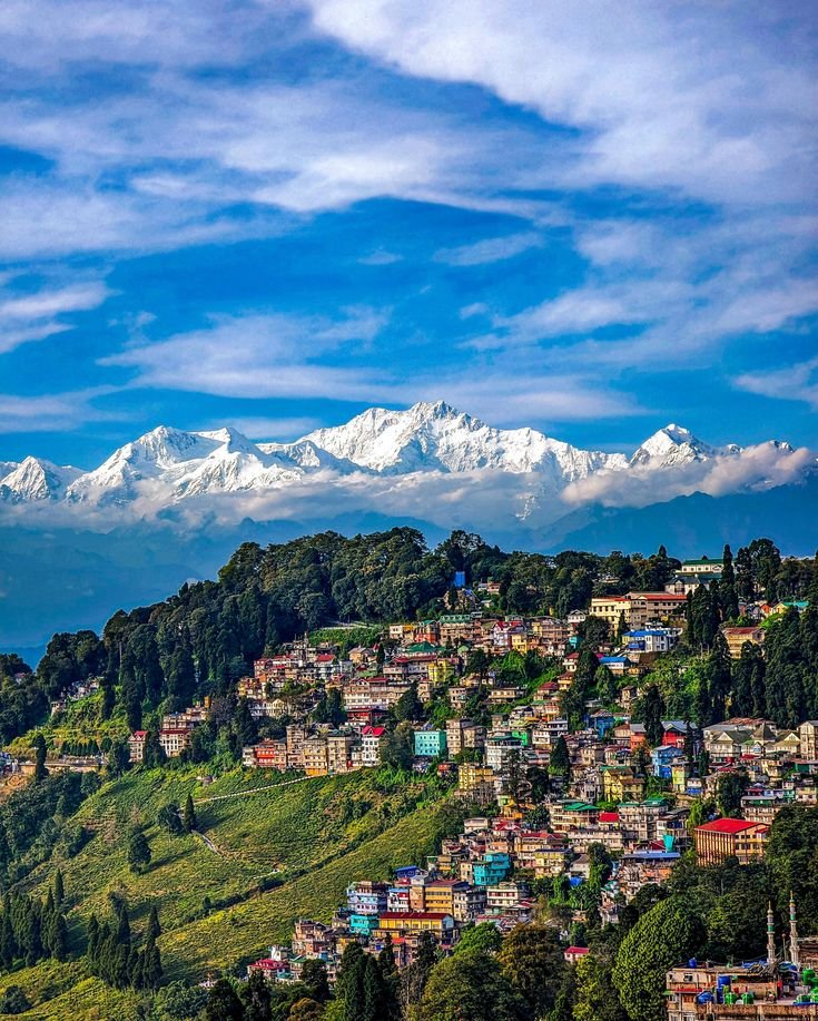 This may contain: the mountains are covered with snow capped peaks