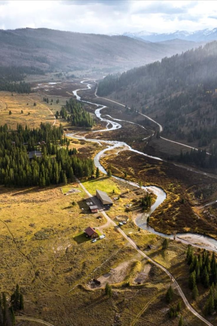 This may contain: an aerial view of a river running through a valley