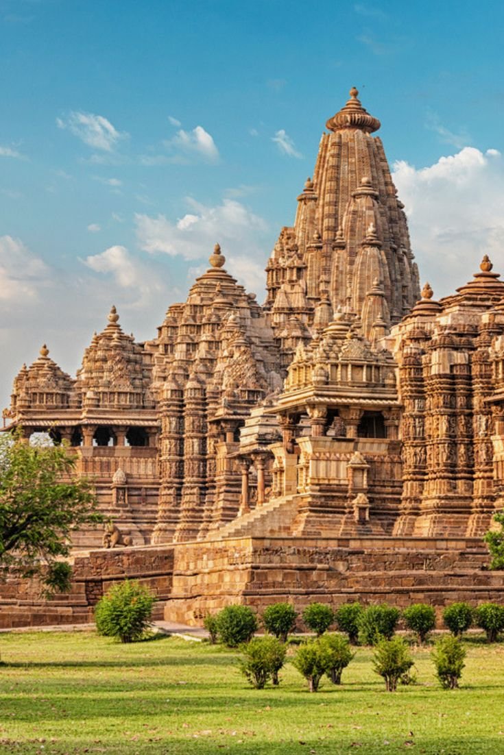 This may contain: an ornately carved building with trees in the foreground
