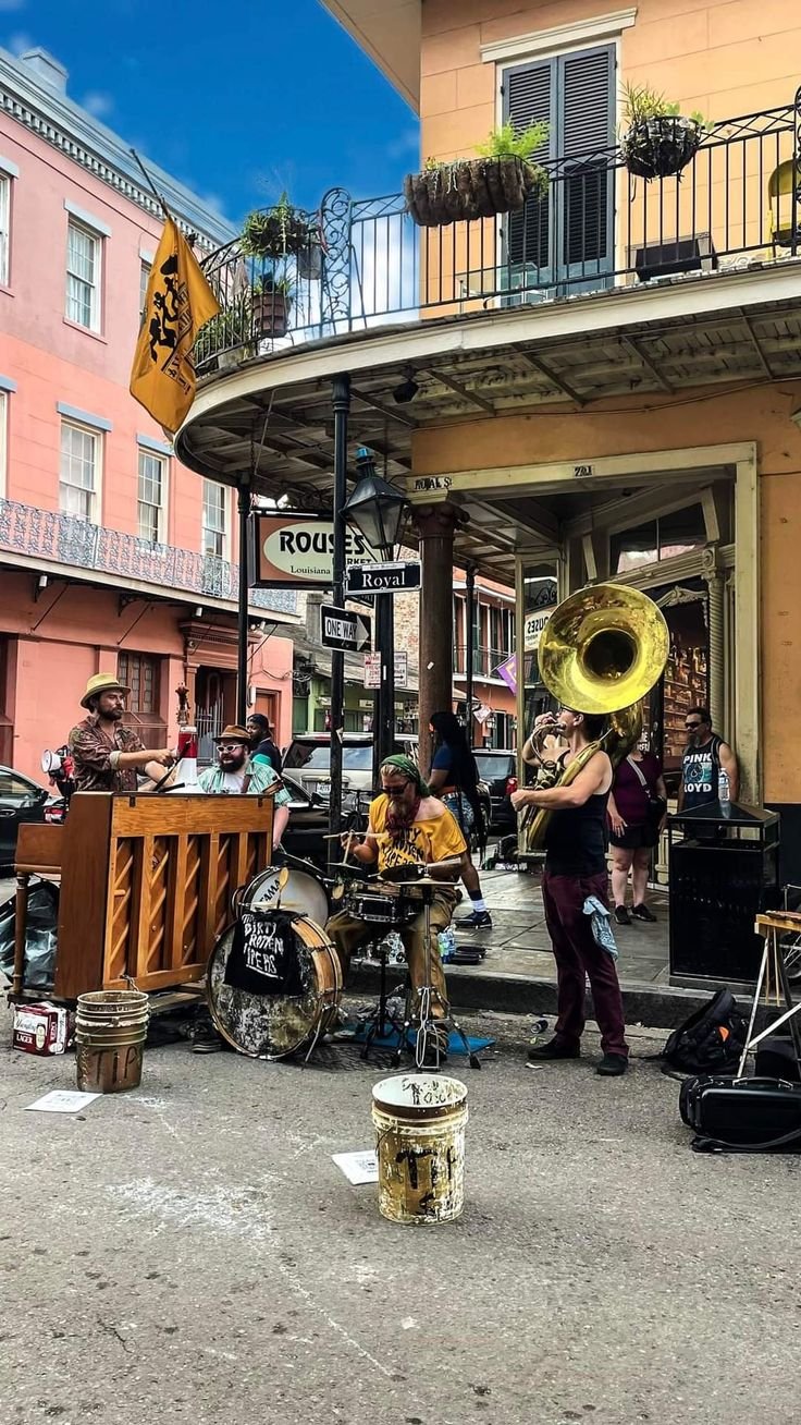 This may contain: a group of people playing instruments in front of a building