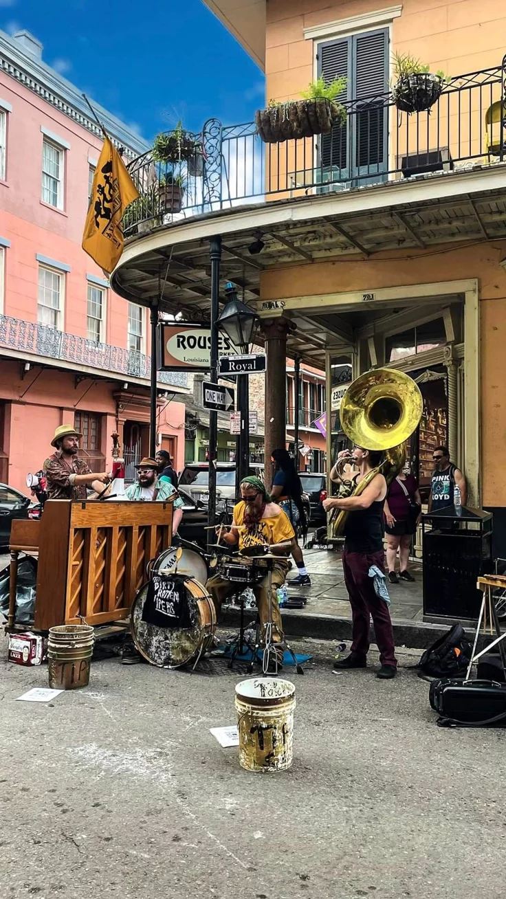 This may contain: a group of people playing instruments in front of a building