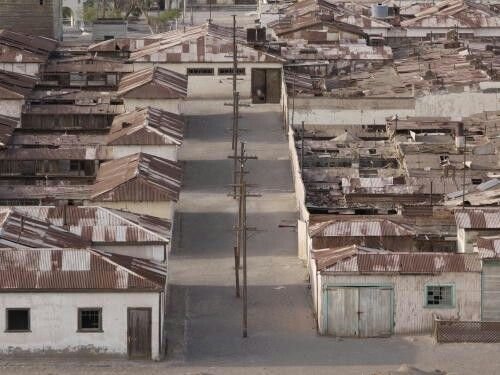 This may contain: an aerial view of a city with lots of old buildings and rusted roof tops