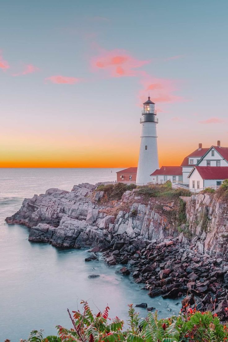 This may contain: the light house is located on top of an island near the ocean at sunset or dawn