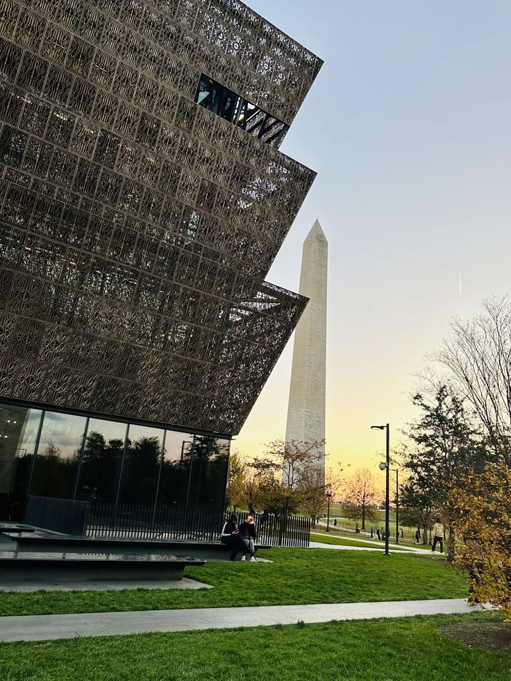 This may contain: the washington monument is in the background as people walk by