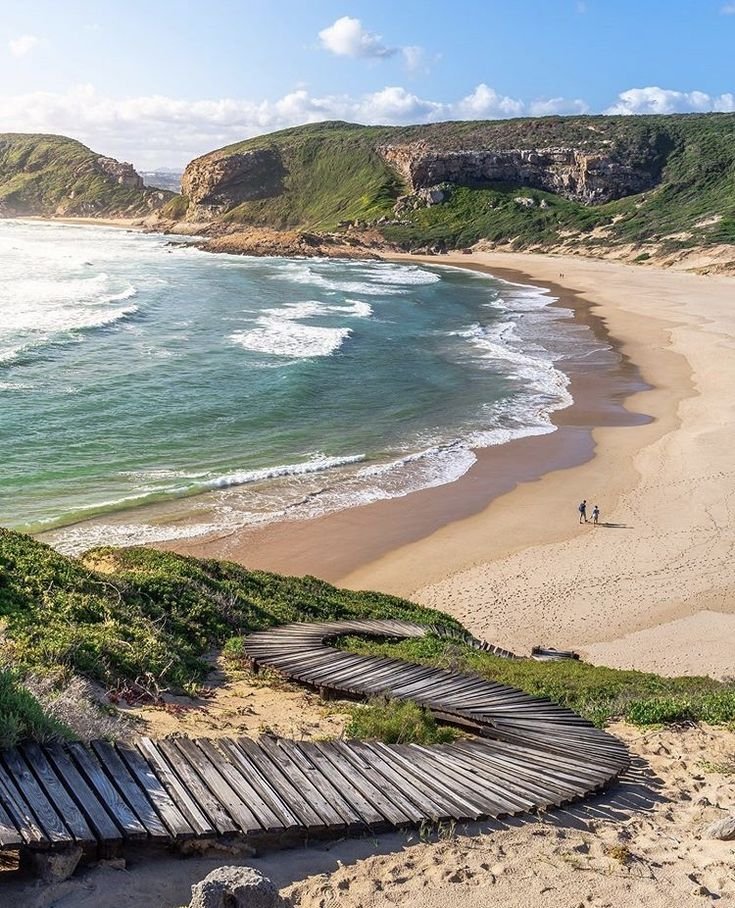 This may contain: an aerial view of a beach with steps leading to the water