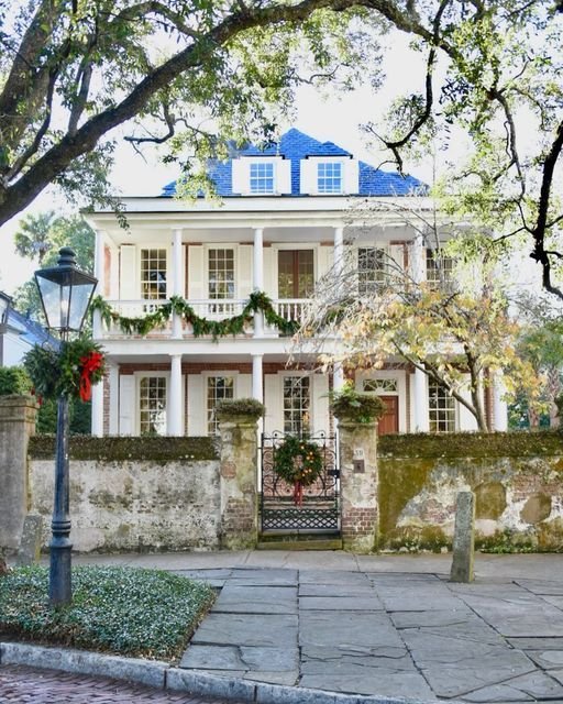 This may contain: the charleston house is decorated for christmas