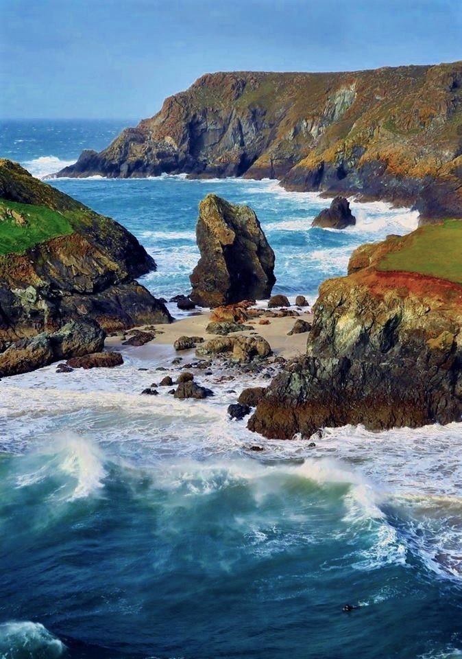 This may contain: an ocean view with waves crashing on the rocks