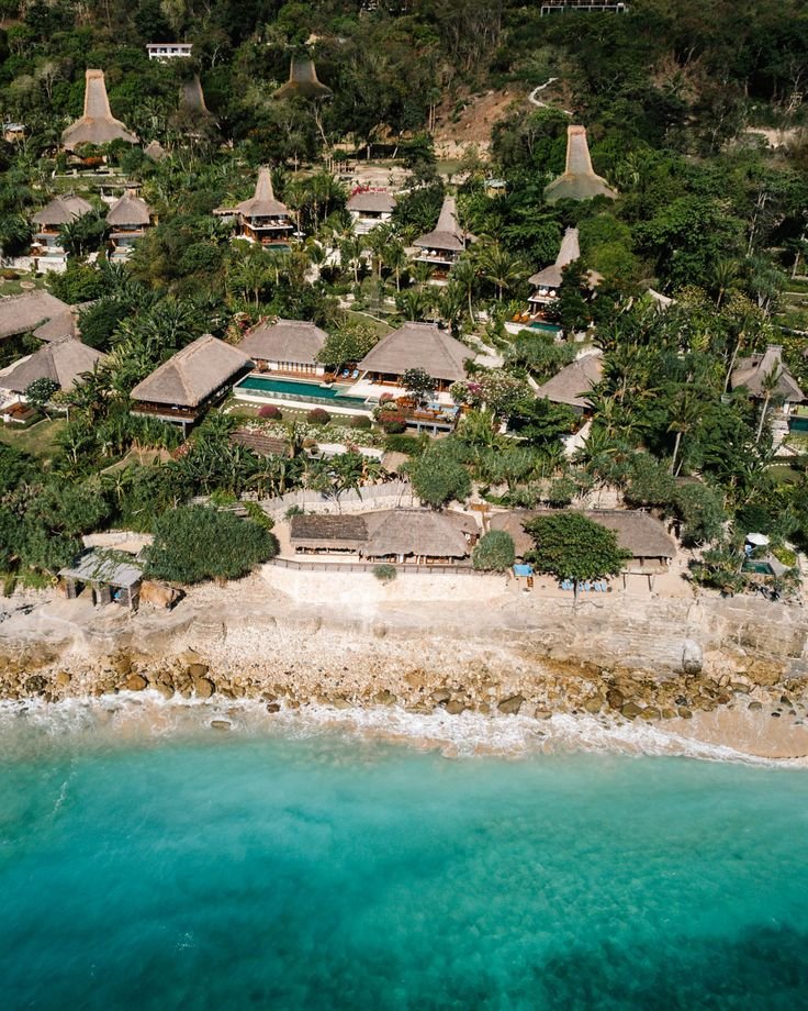 This may contain: an aerial view of a tropical resort and beach